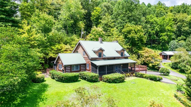 a aerial view of a house with yard and green space