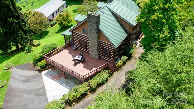 a view of a house with a small pool and a bench
