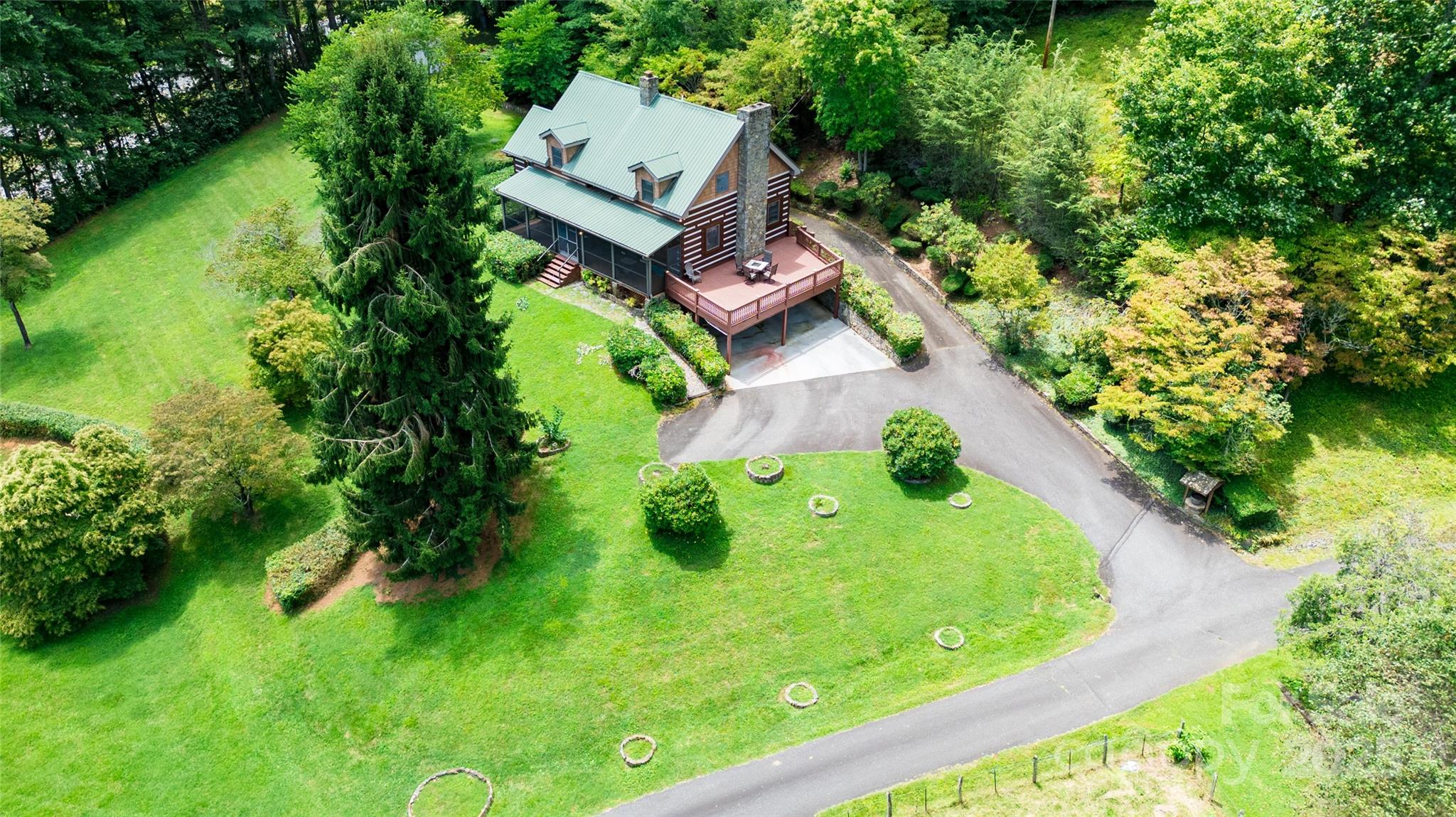83 Daybreak Ridge Sylva, NC 28779 - Photo 39 of 40 an aerial view of a house with swimming pool and garden