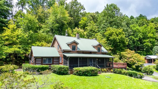a view of a house with a yard and potted plants