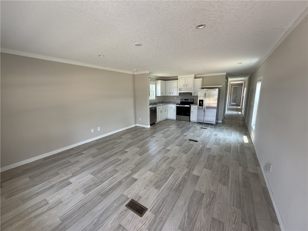 108 Candlestick Lane Seneca, SC 29678 - Photo 14 of 14 An open floor plan seamlessly connects a sleek kitchen to a spacious living area, ideal for modern living.