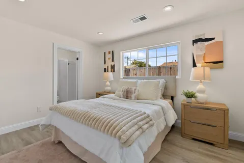 a bedroom with a bed and a window