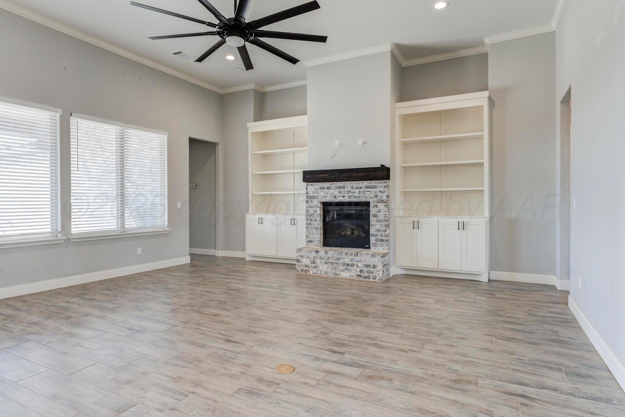 14310 Lobelia Place Amarillo, TX 79119 - Photo 13 of 78 a view of an empty room with a fireplace and a window