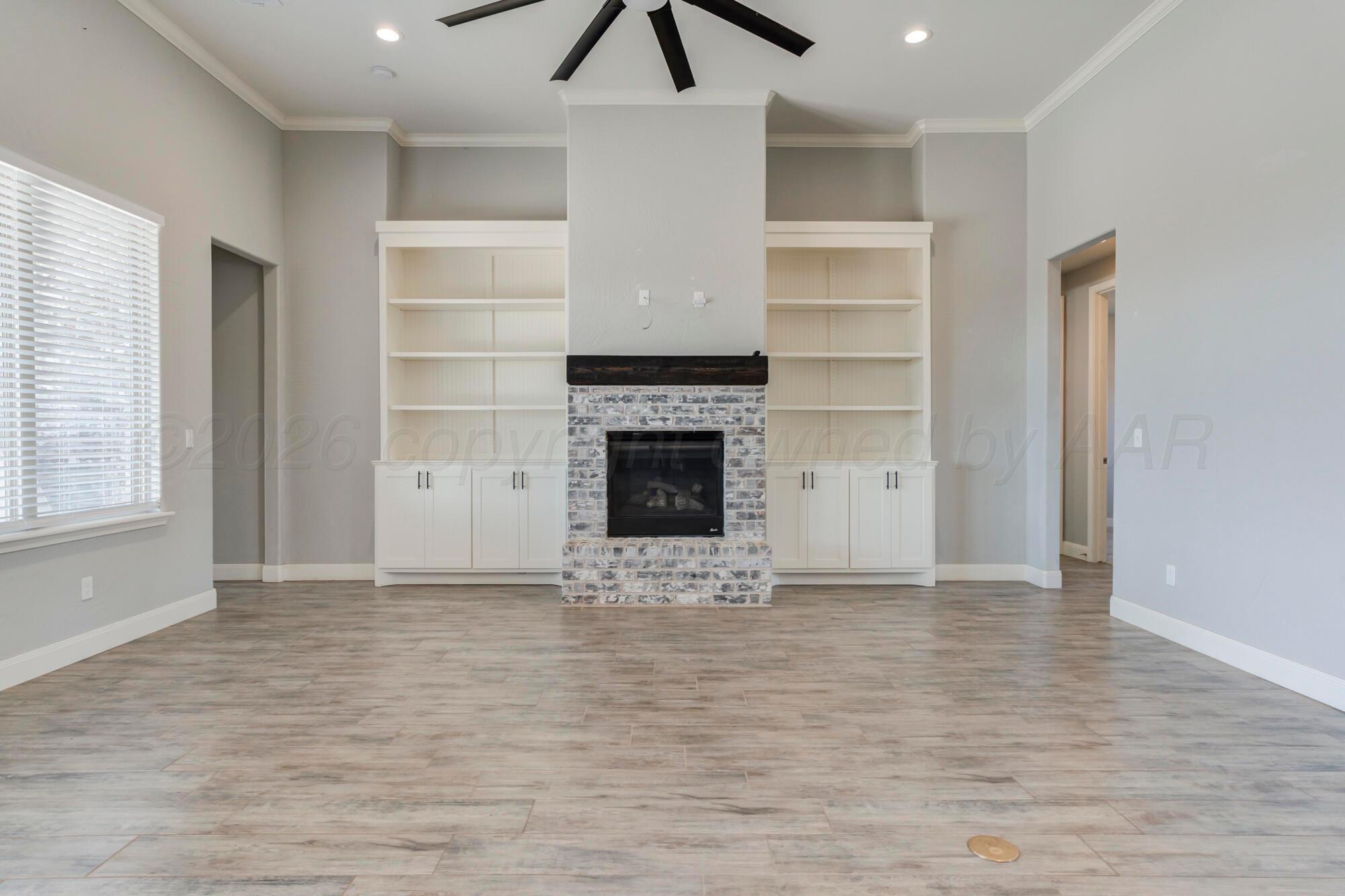 14310 Lobelia Place Amarillo, TX 79119 - Photo 14 of 78 a view of an empty room with a fireplace and a window
