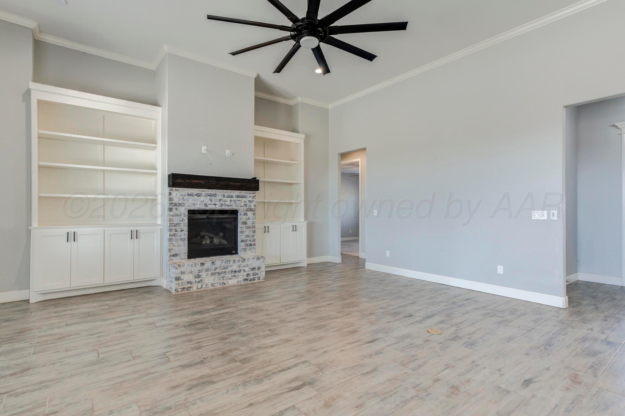 14310 Lobelia Place Amarillo, TX 79119 - Photo 15 of 78 a view of an empty room with a fireplace and a window