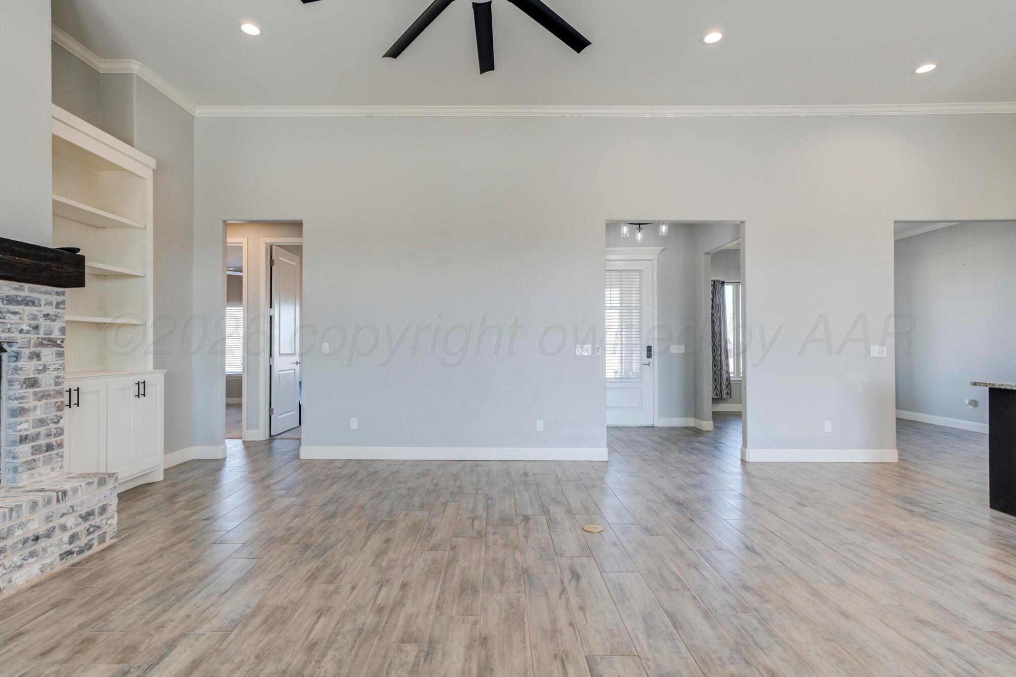 14310 Lobelia Place Amarillo, TX 79119 - Photo 16 of 78 a view of an empty room with wooden floor and a window