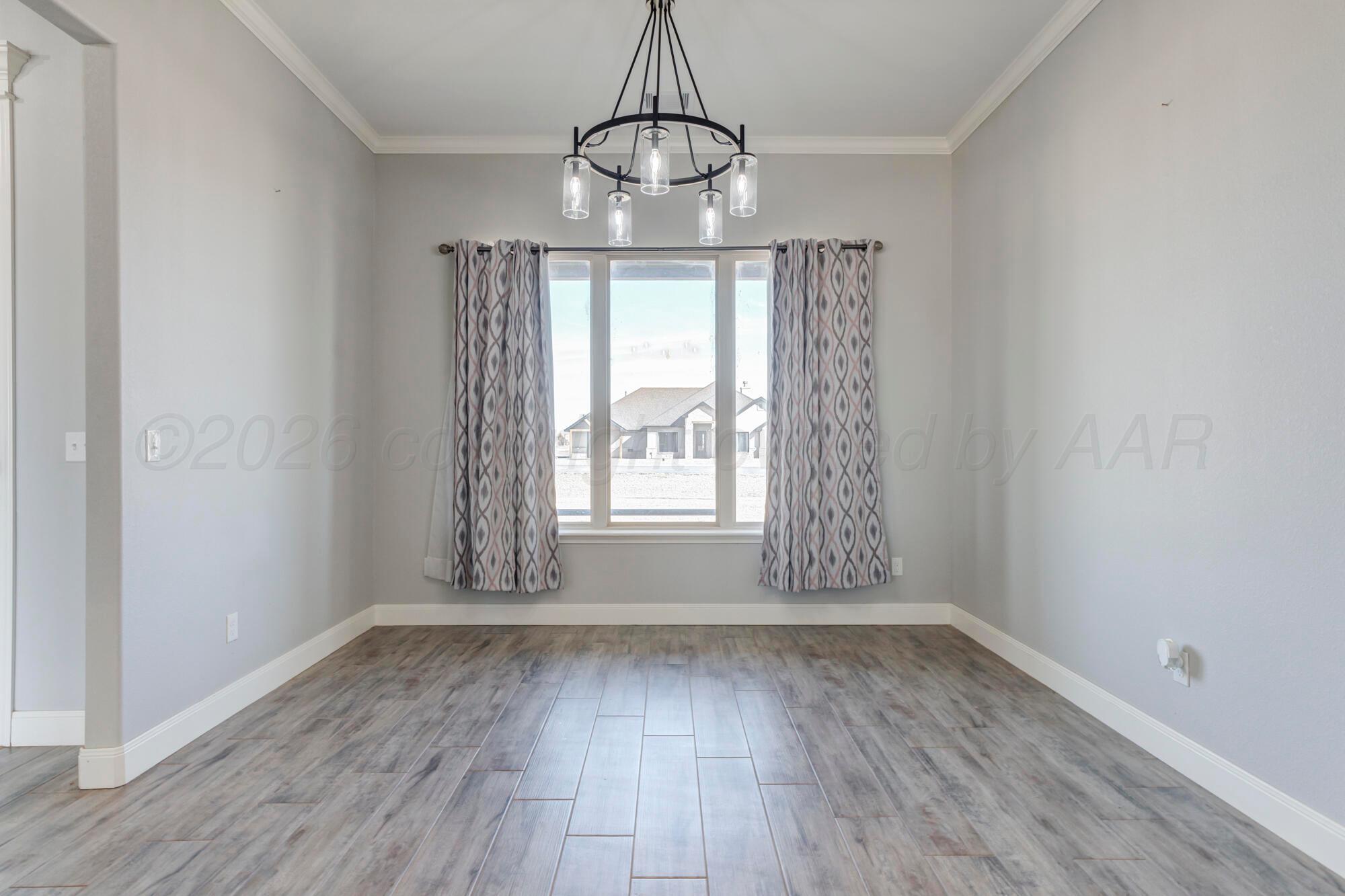 14310 Lobelia Place Amarillo, TX 79119 - Photo 22 of 78 a view of a room with wooden floor chandelier and window