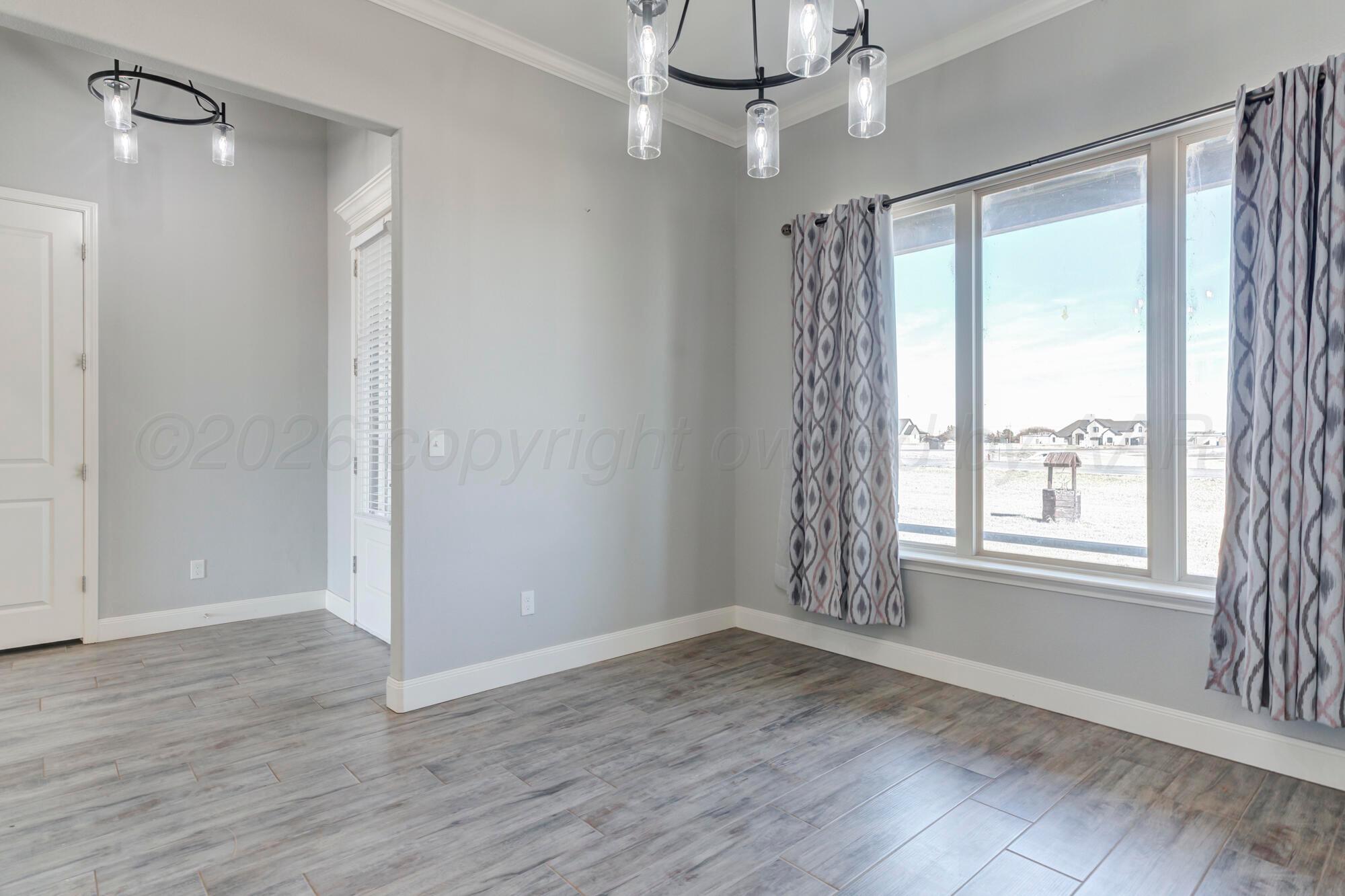 14310 Lobelia Place Amarillo, TX 79119 - Photo 23 of 78 wooden floor in an empty room with a window