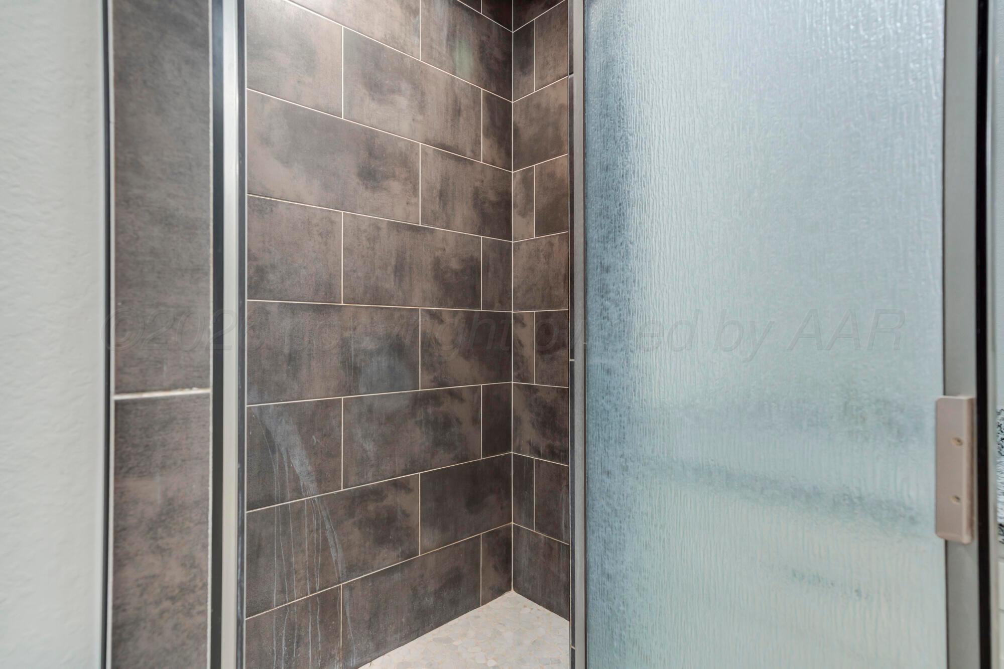 14310 Lobelia Place Amarillo, TX 79119 - Photo 31 of 78 a bathroom with a glass shower door