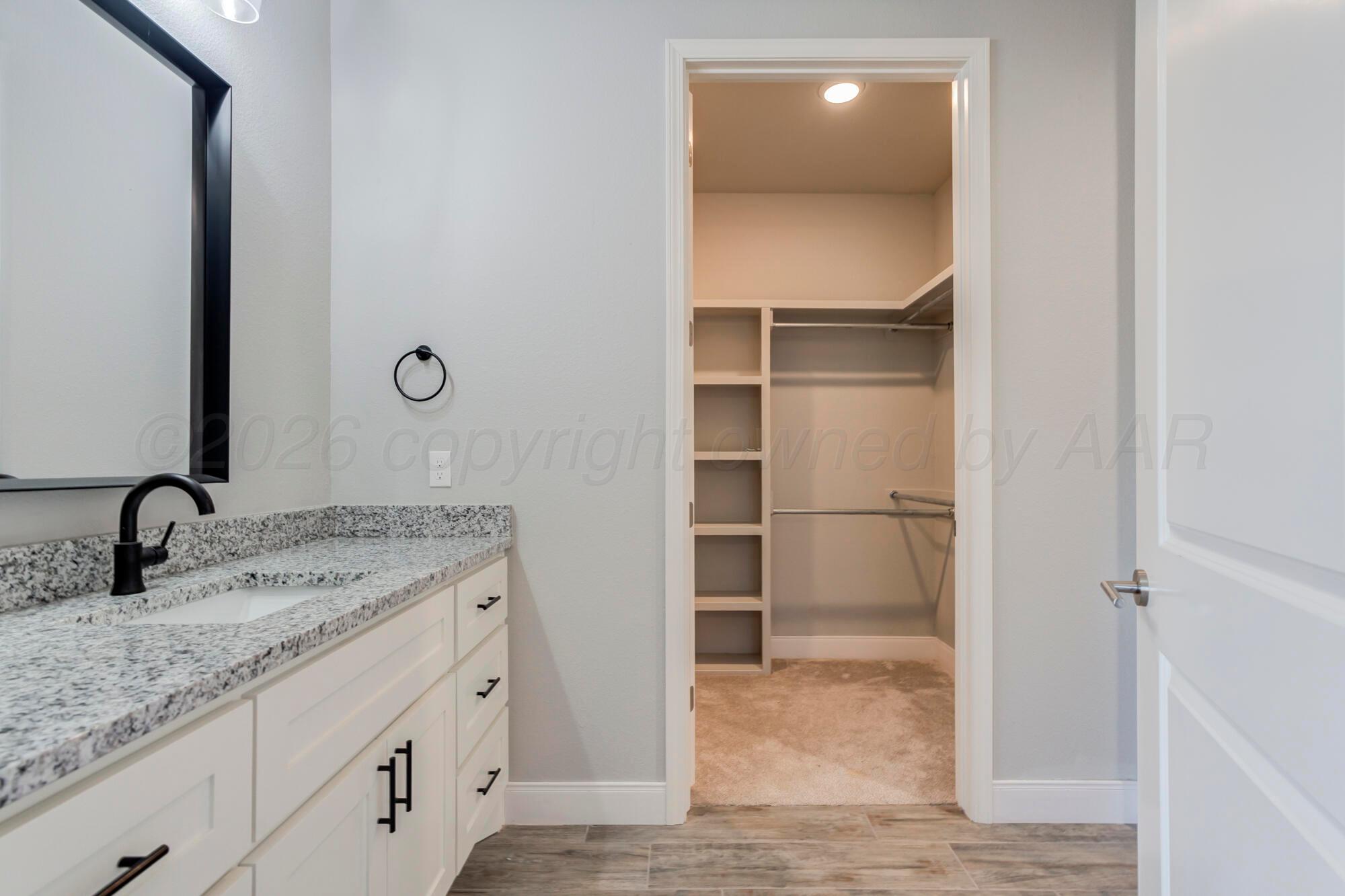 14310 Lobelia Place Amarillo, TX 79119 - Photo 38 of 78 a bathroom with a granite countertop sink and a mirror