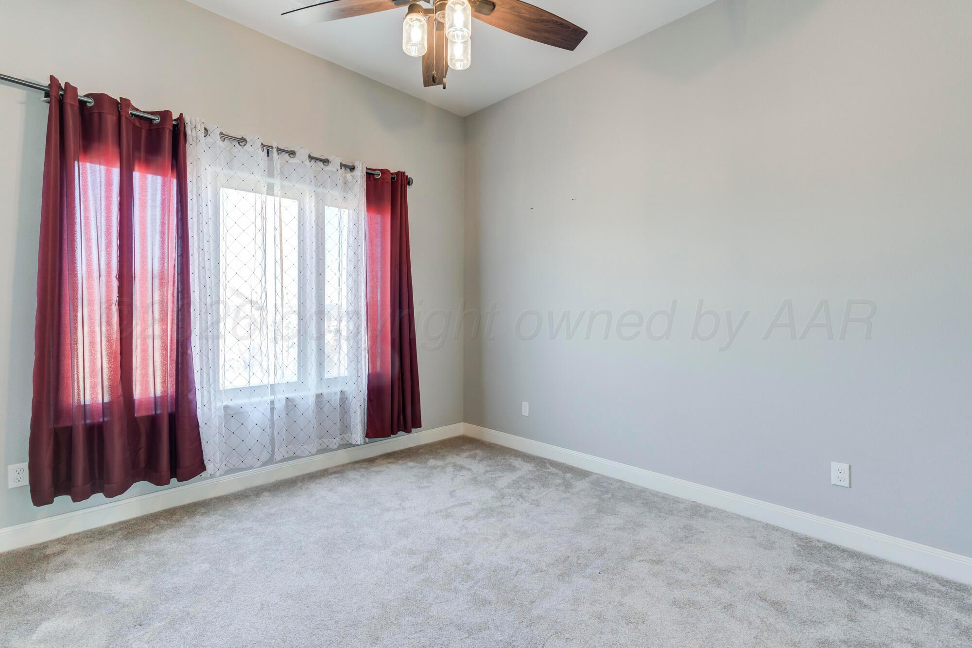 14310 Lobelia Place Amarillo, TX 79119 - Photo 45 of 78 an empty room with windows and a chandelier fan