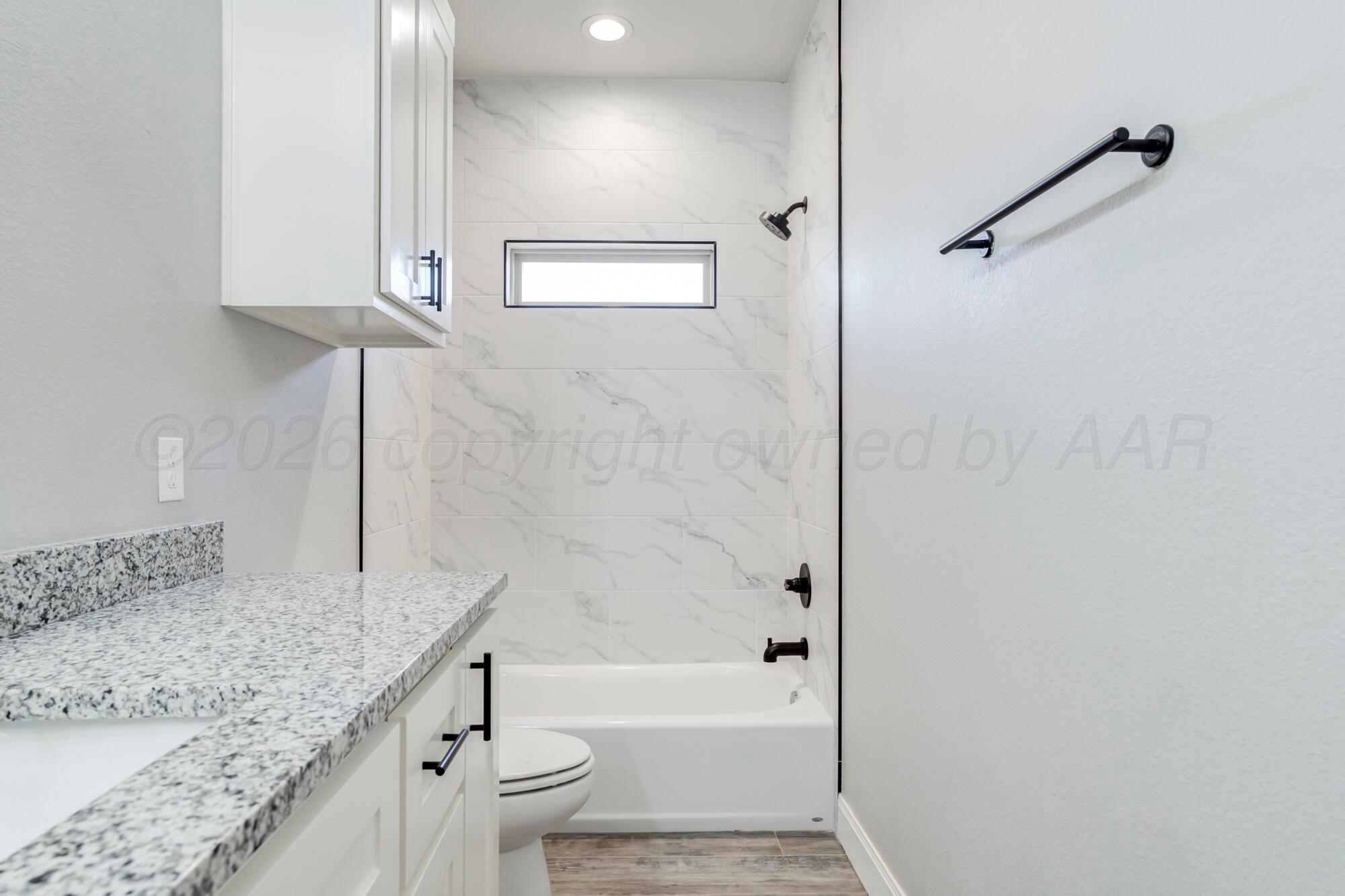 14310 Lobelia Place Amarillo, TX 79119 - Photo 46 of 78 a bathroom with a granite countertop sink a toilet and bathtub
