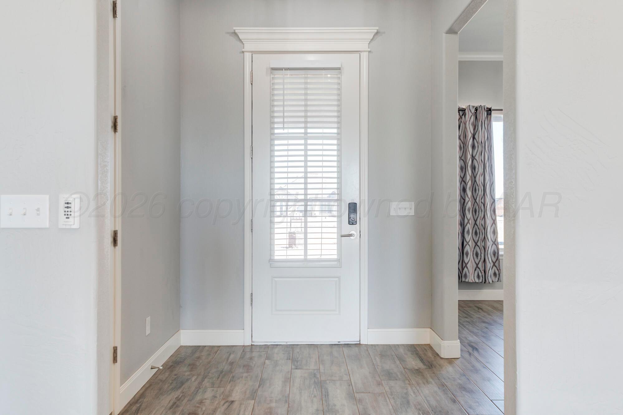 14310 Lobelia Place Amarillo, TX 79119 - Photo 67 of 78 a view of an empty room with wooden floor and a window