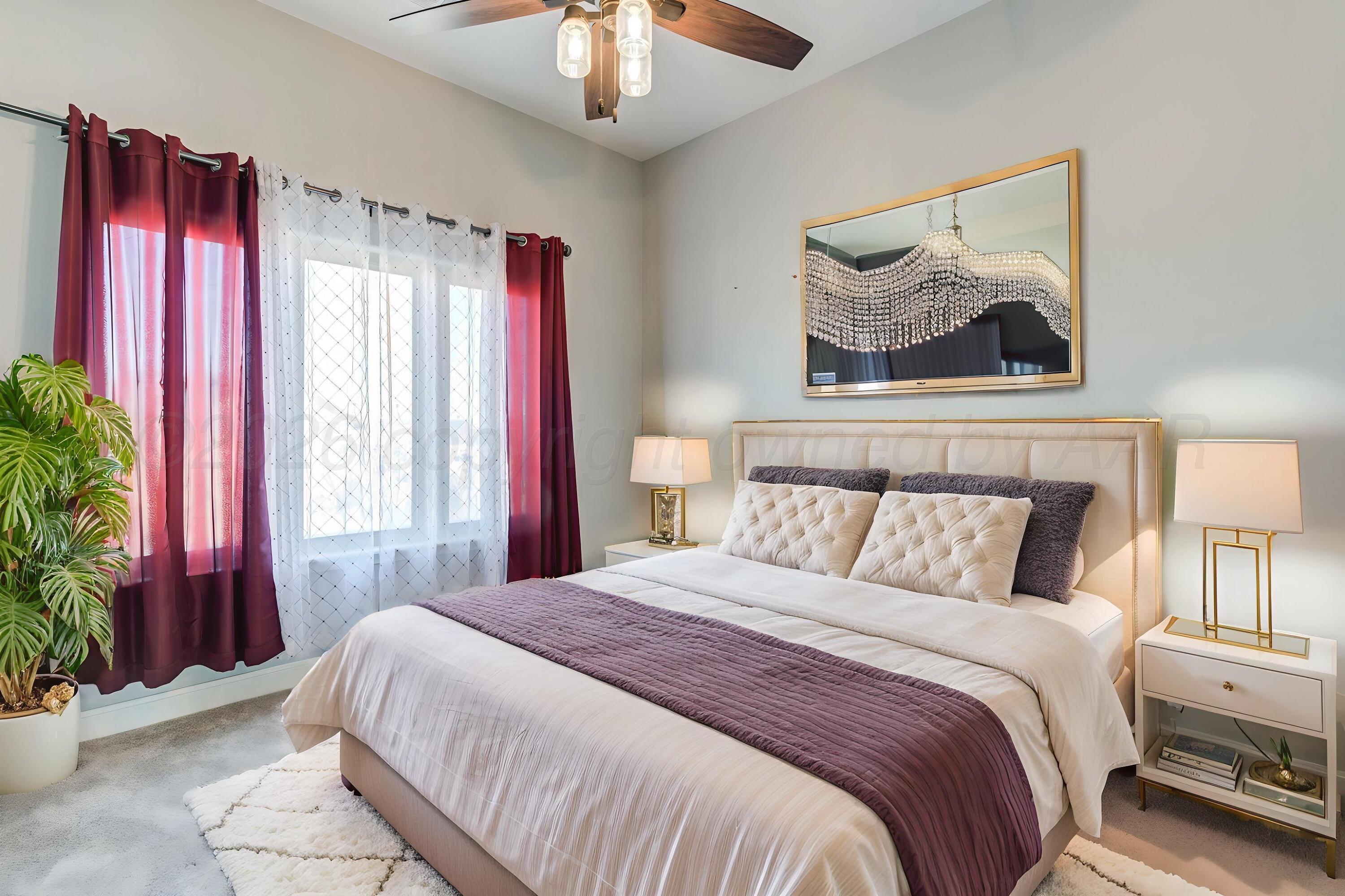 14310 Lobelia Place Amarillo, TX 79119 - Photo 75 of 78 a bedroom with a large bed and a chandelier