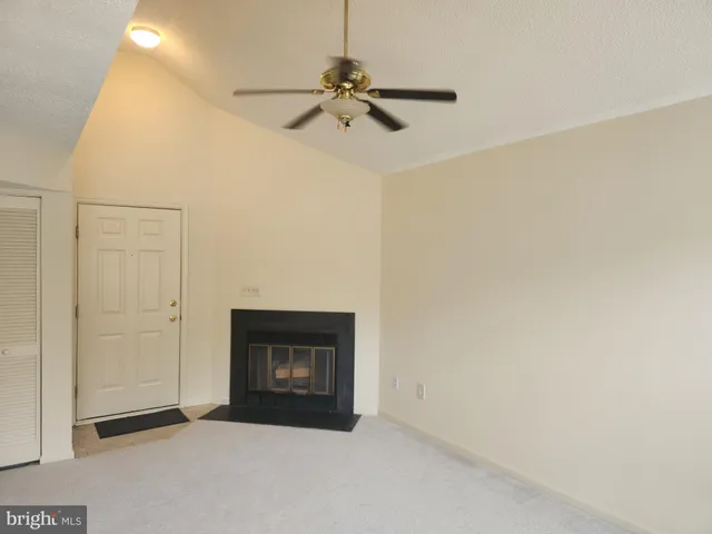a view of an empty room with a fireplace