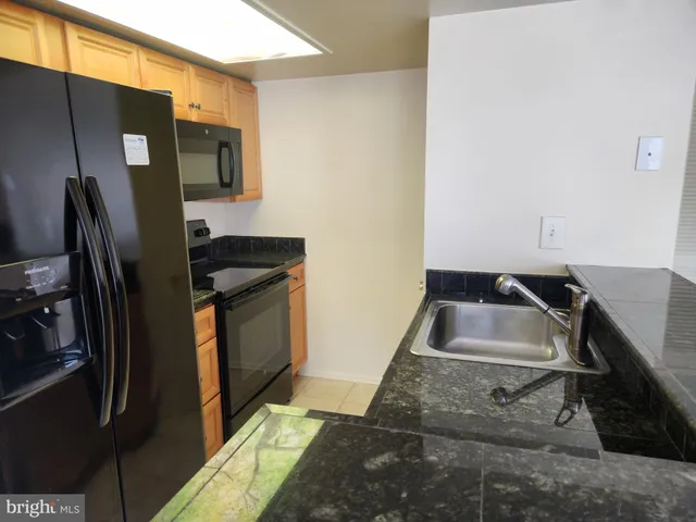 a kitchen that has a sink and a refrigerator