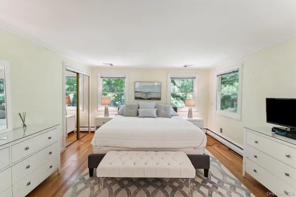 a bedroom with a large bed and a flat screen tv