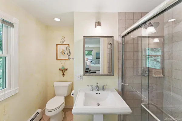 a bathroom with a sink toilet and shower