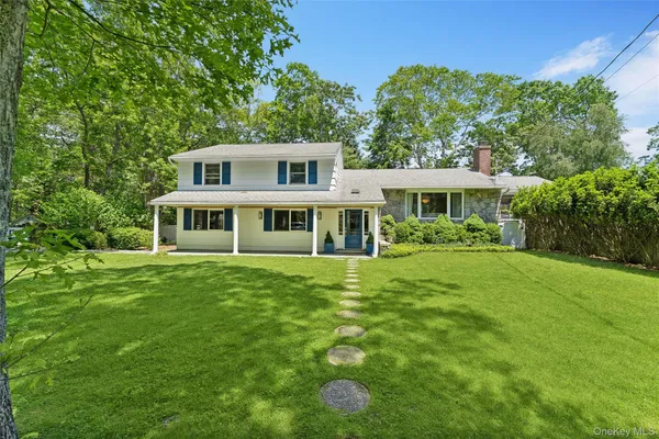 a front view of a house with a yard table and chairs