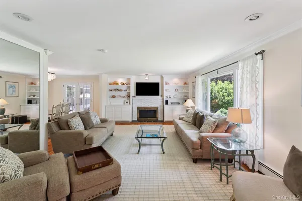 a living room with furniture flat screen tv and a fireplace
