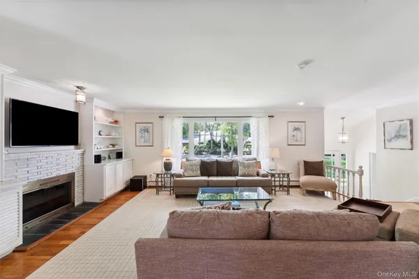 a living room with fireplace furniture and a flat screen tv