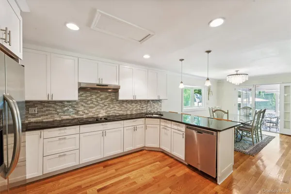 a kitchen with granite countertop a sink and cabinets