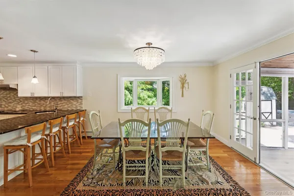 a view of a dining room with furniture wooden floor and a rug