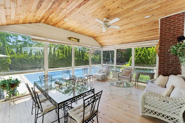 a view of a patio with furniture and wooden floor