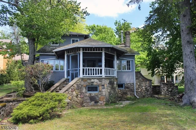 a view of house with yard and sitting area