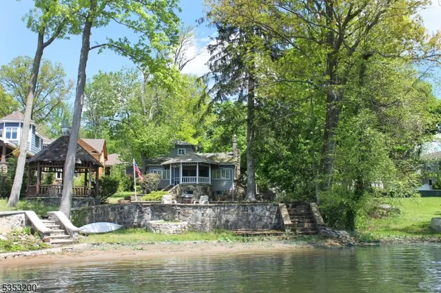 a front view of a house with swimming pool and a yard