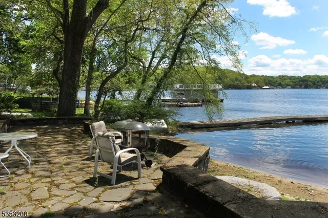 a view of a lake with chairs