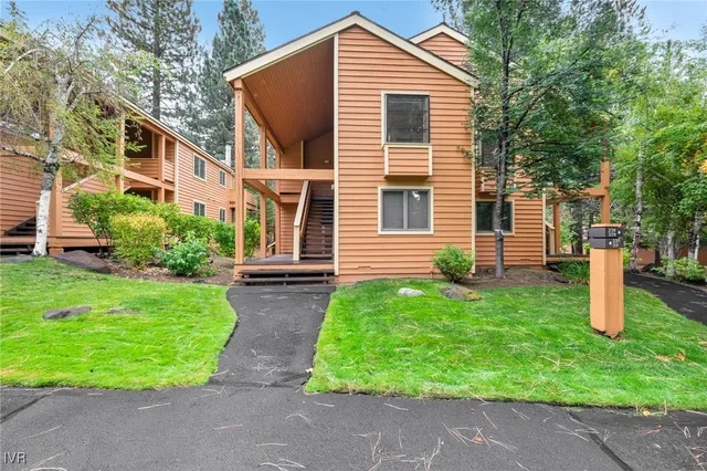 an aerial view of residential house with outdoor space and trees all around