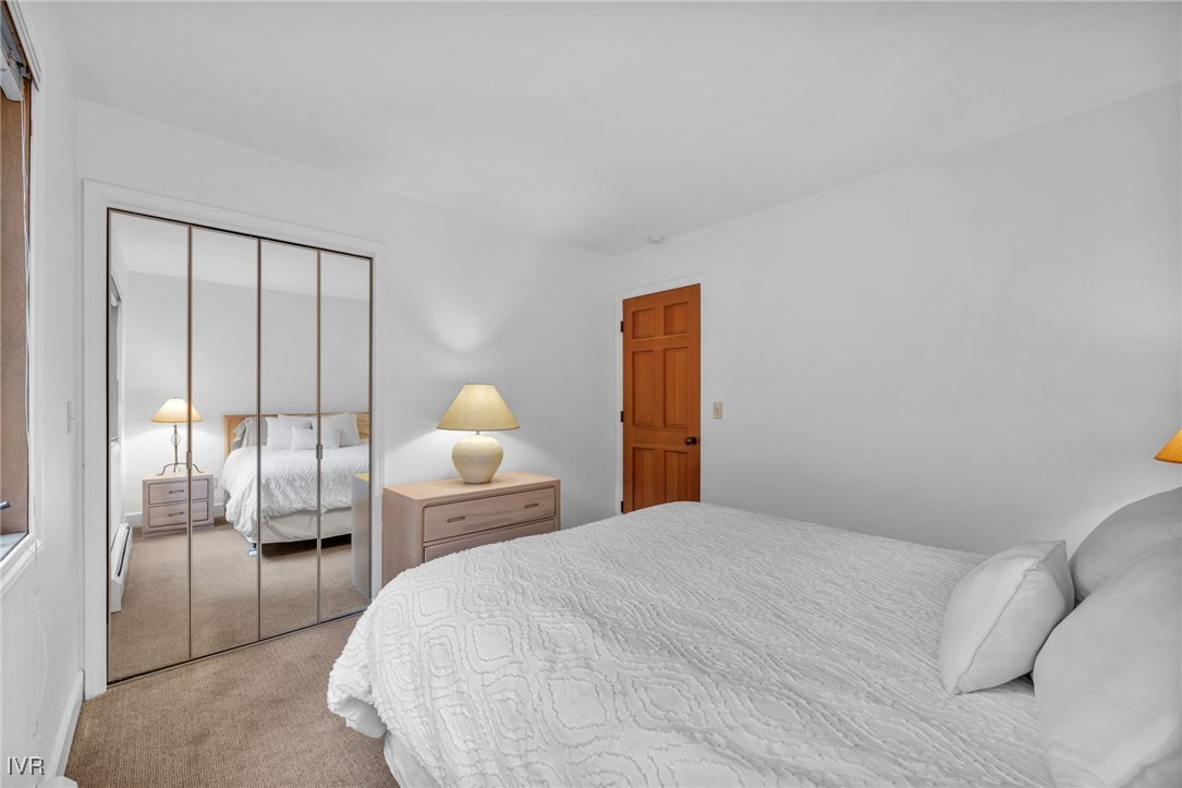 931 Incline Way, Unit 231 Incline Village, NV 89451 - Photo 24 of 39 a bedroom with a bed a lamp and window