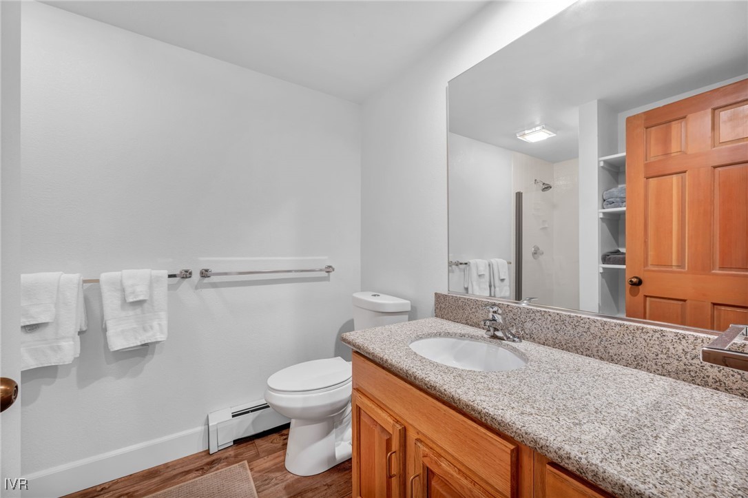 931 Incline Way, Unit 231 Incline Village, NV 89451 - Photo 25 of 39 a bathroom with a granite countertop sink a toilet and a mirror