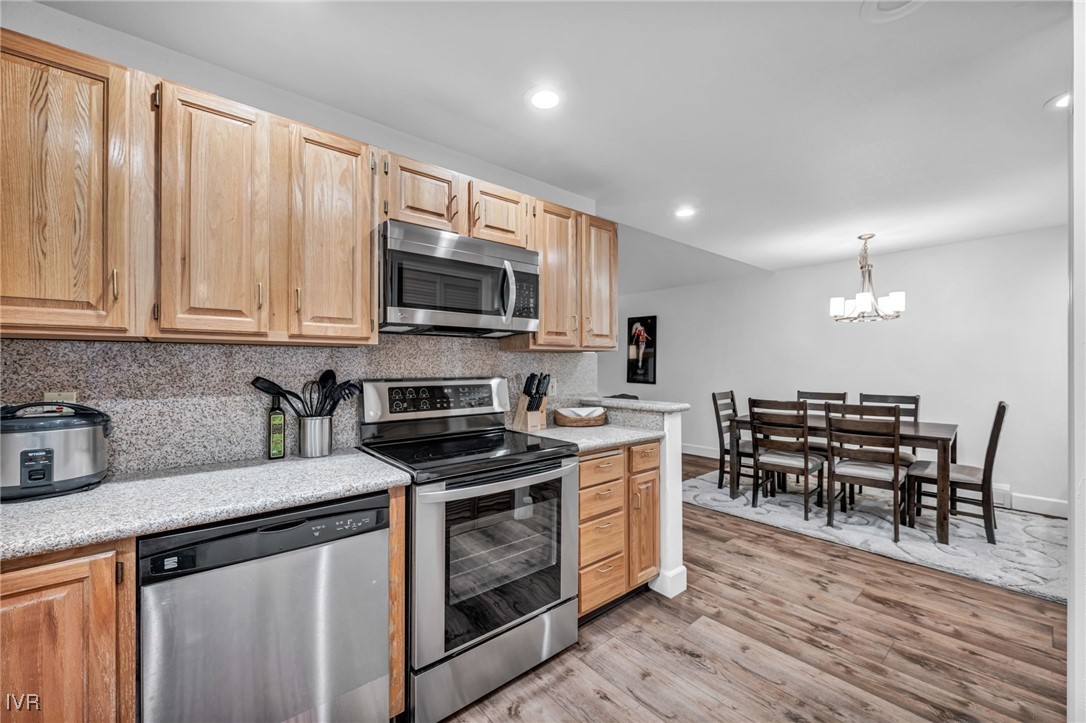 931 Incline Way, Unit 231 Incline Village, NV 89451 - Photo 30 of 39 a kitchen with stainless steel appliances a stove a sink a microwave a dining table and chairs