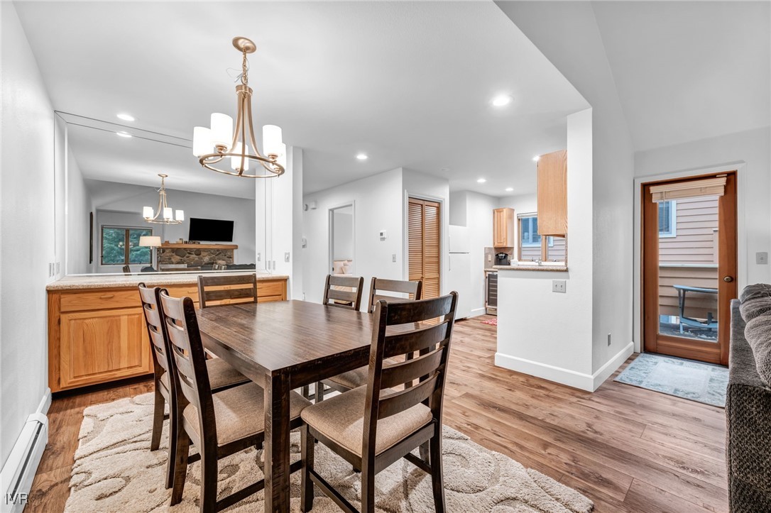 931 Incline Way, Unit 231 Incline Village, NV 89451 - Photo 34 of 39 a view of a dining room and livingroom with furniture wooden floor a chandelier