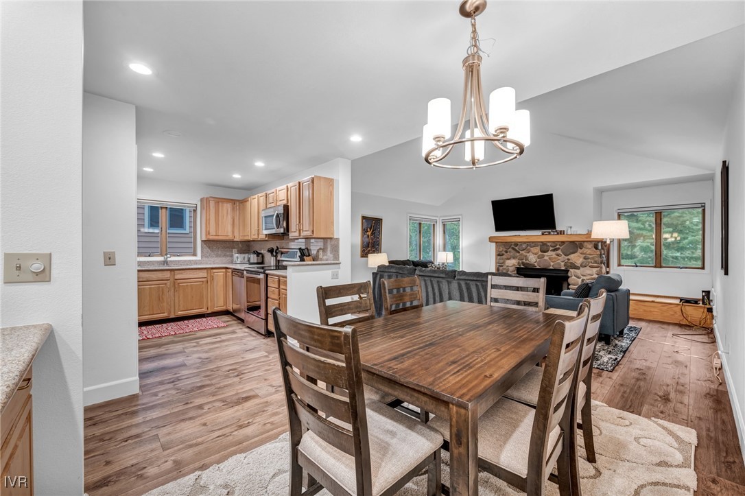 931 Incline Way, Unit 231 Incline Village, NV 89451 - Photo 35 of 39 a view of a dining room with furniture a chandelier and wooden floor