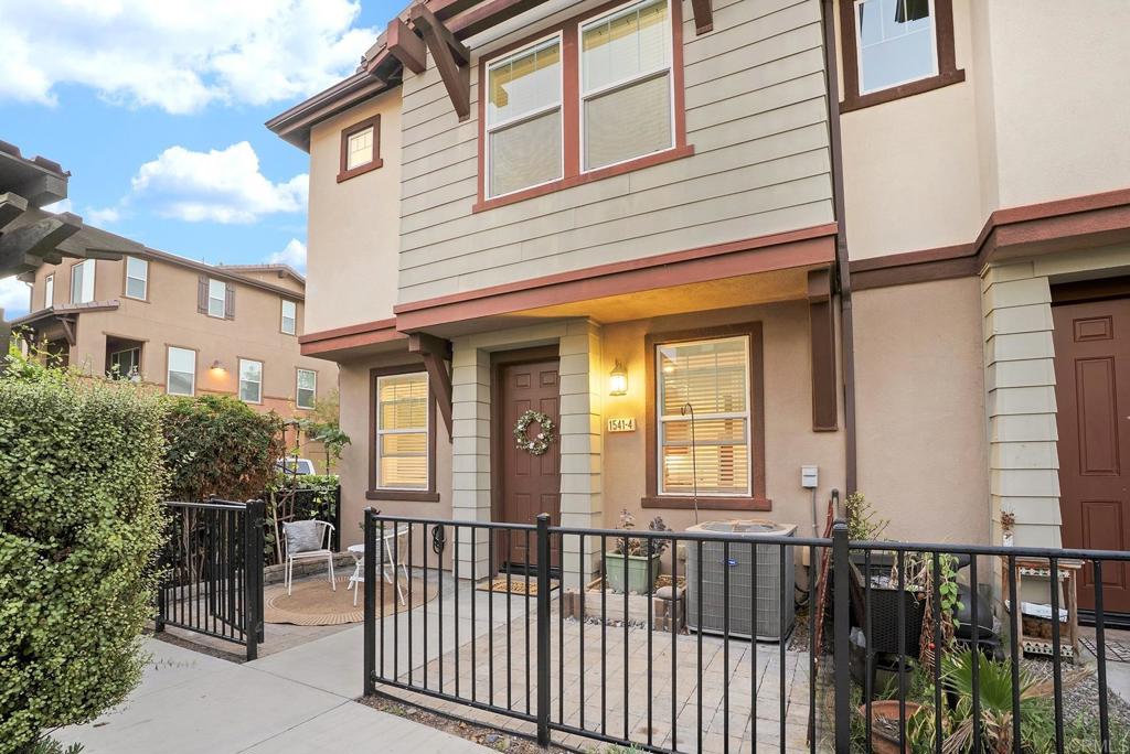 1541 Winter Lane, Unit 4 Chula Vista, CA 91915 - Photo 1 of 23 a view of a house with a small yard and wooden fence