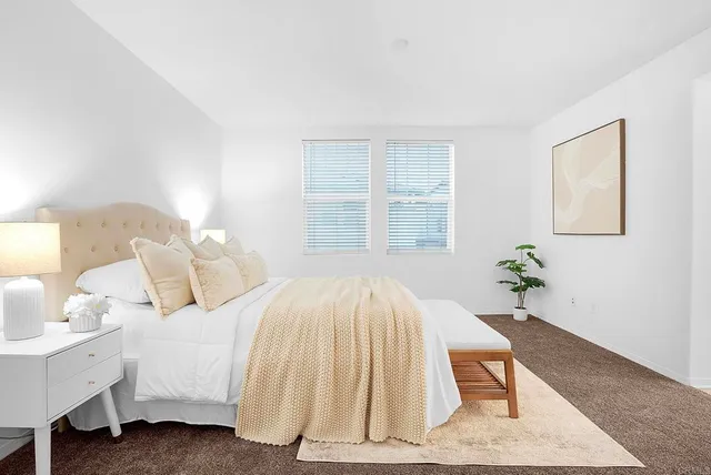 a bedroom with a bed and a table