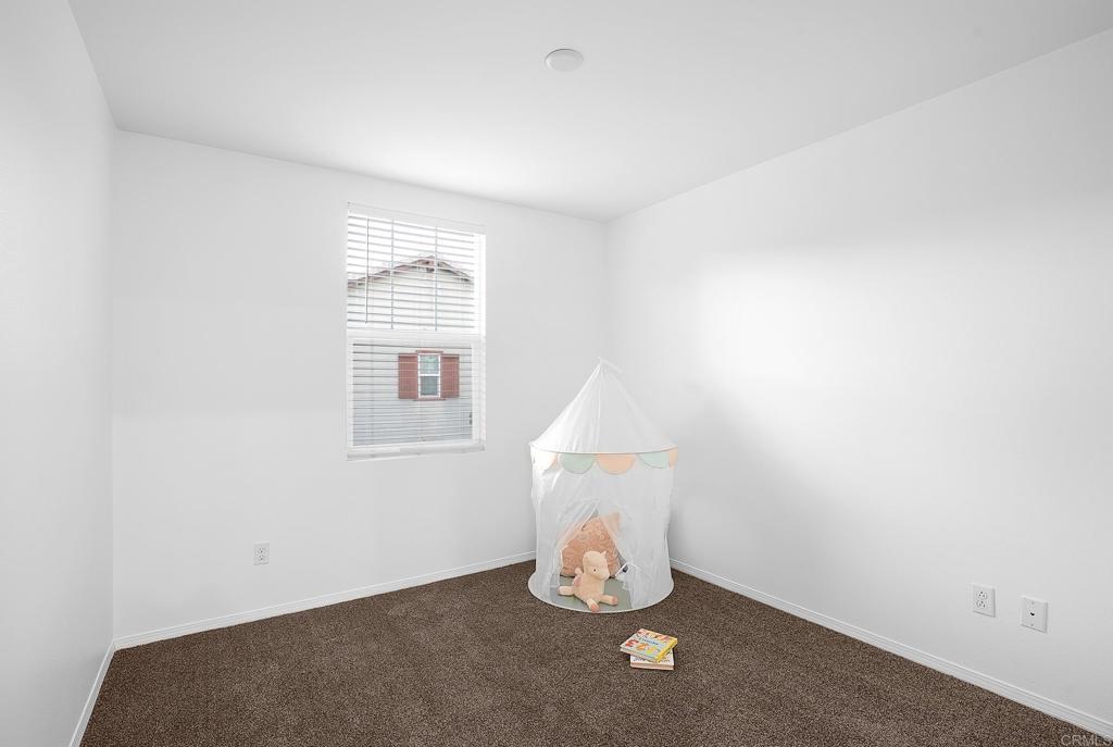 1541 Winter Lane, Unit 4 Chula Vista, CA 91915 - Photo 16 of 23 a view of an empty room with wooden floor and a window