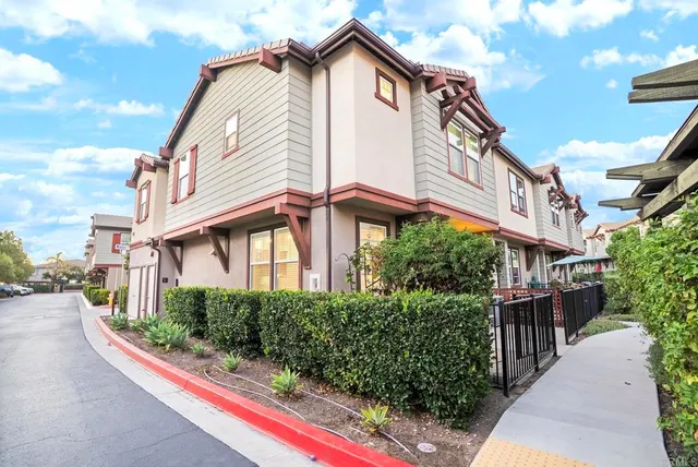 a view of a house with wooden fence