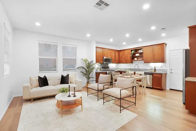 a living room with furniture and kitchen view