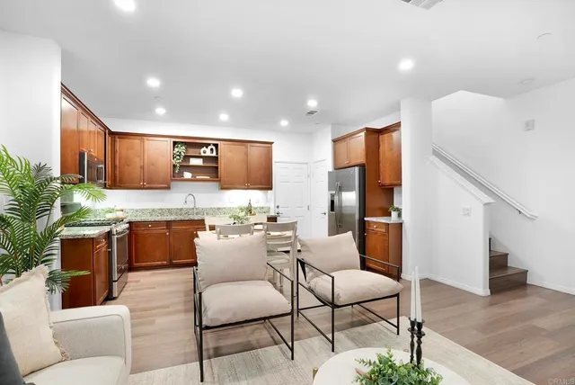 a view of kitchen with kitchen island dining table and chairs
