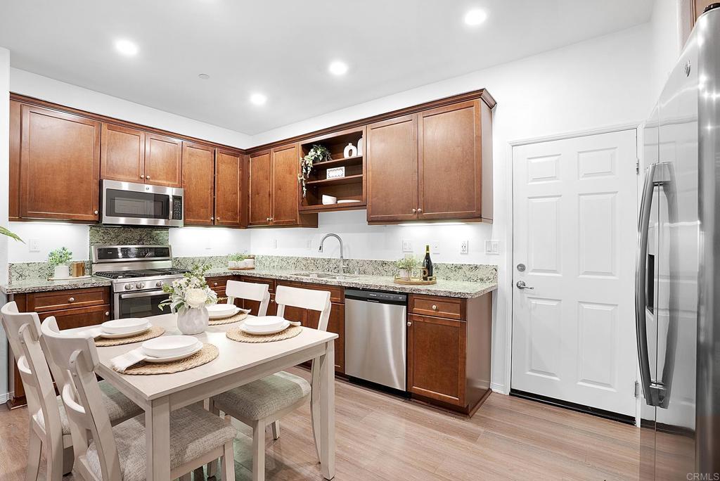 1541 Winter Lane, Unit 4 Chula Vista, CA 91915 - Photo 6 of 23 a kitchen with stainless steel appliances granite countertop a refrigerator a stove top oven a sink and dishwasher