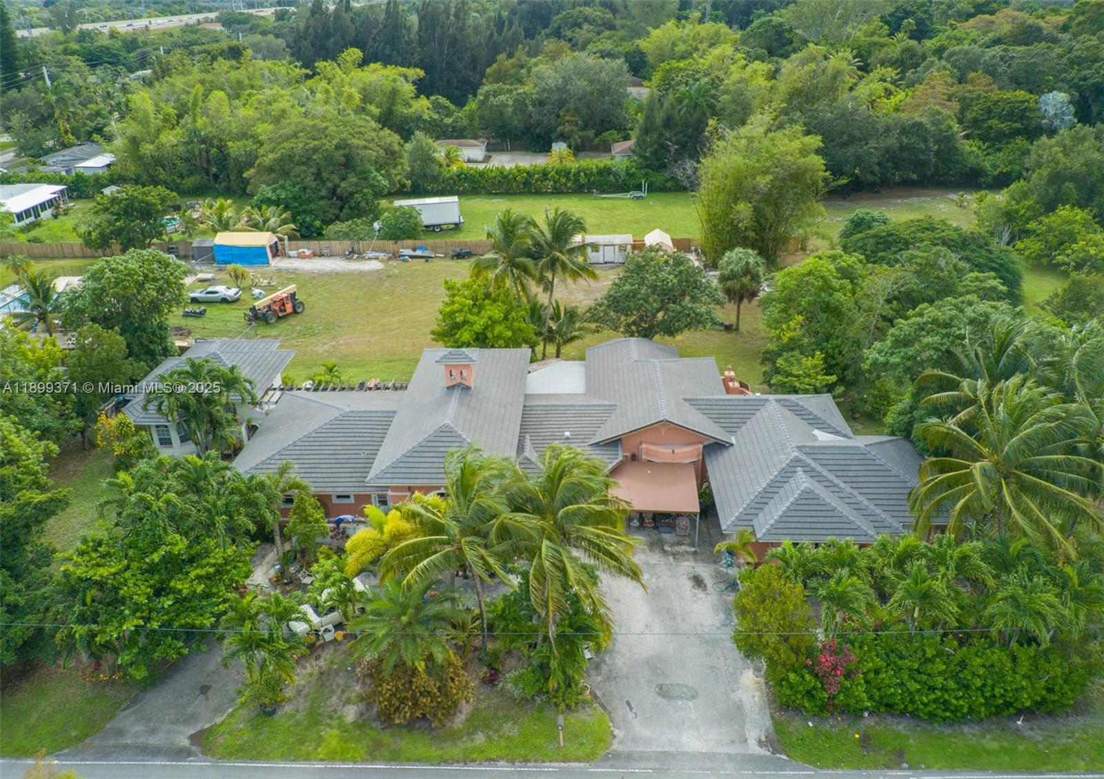 an aerial view of a house with a yard and lake view