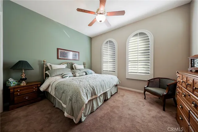 a spacious bedroom with a bed a couch and a window