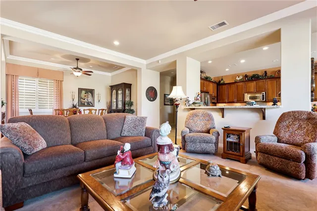 a living room with furniture kitchen view and a table