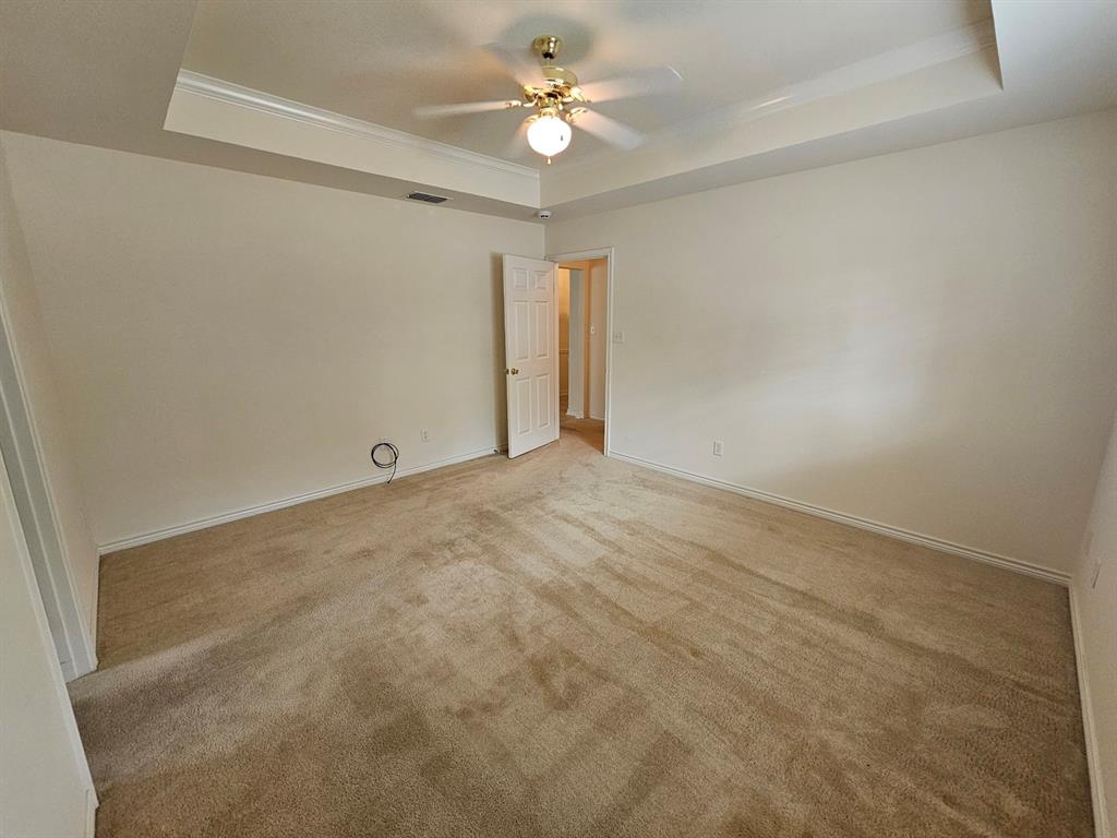 1521 Rice Road, Unit Z101 Tyler, TX 75703 - Photo 12 of 25 Walk-in closet with carpet flooring, multiple shelving units, and integrated hanging rods