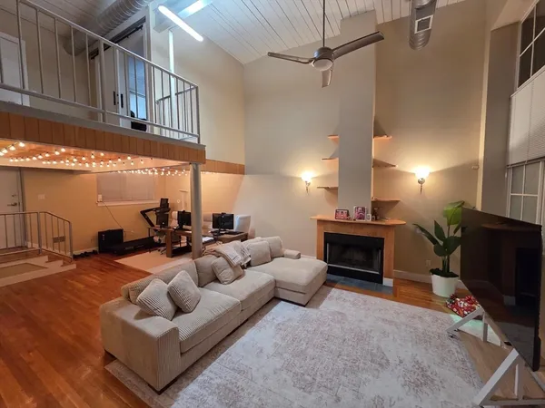 a living room with furniture a fireplace and a flat screen tv