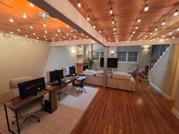 a living room with lots of furniture and a wooden floor